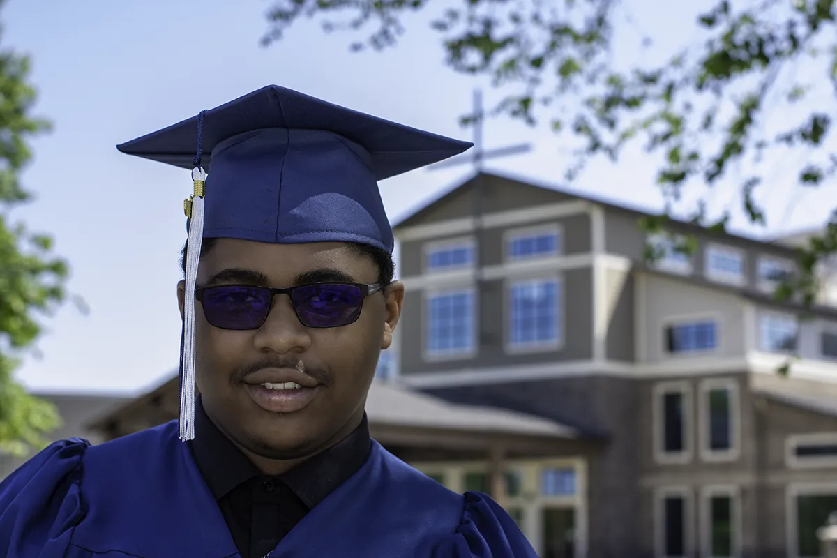 Graduation portrait by SJRIMAGES– blue cap and gown with sunglasses