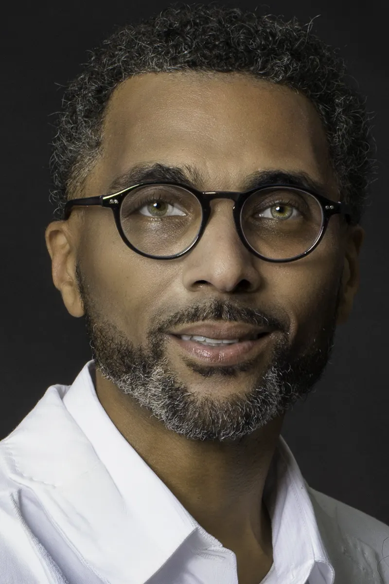 Professional male headshot  by SJRIMAGES - with glasses on dark backdrop